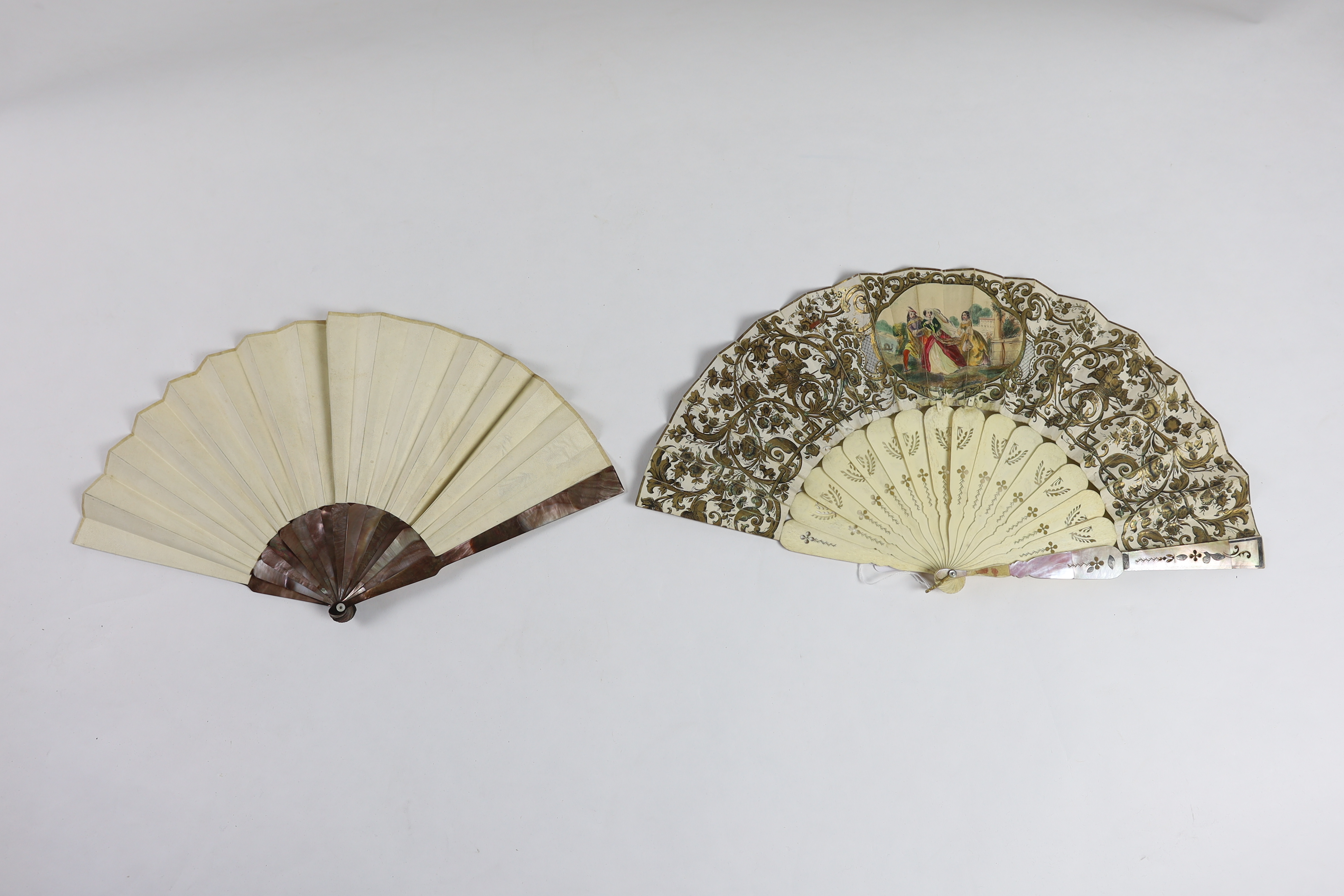 A 19th century mother of pearl and carved bone fan with ornate printed paper leaf, together with a similar Spanish fan of dancers, with mother of pearl guards, signed.